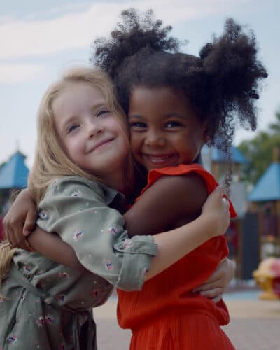 Girls Hugging On Playground