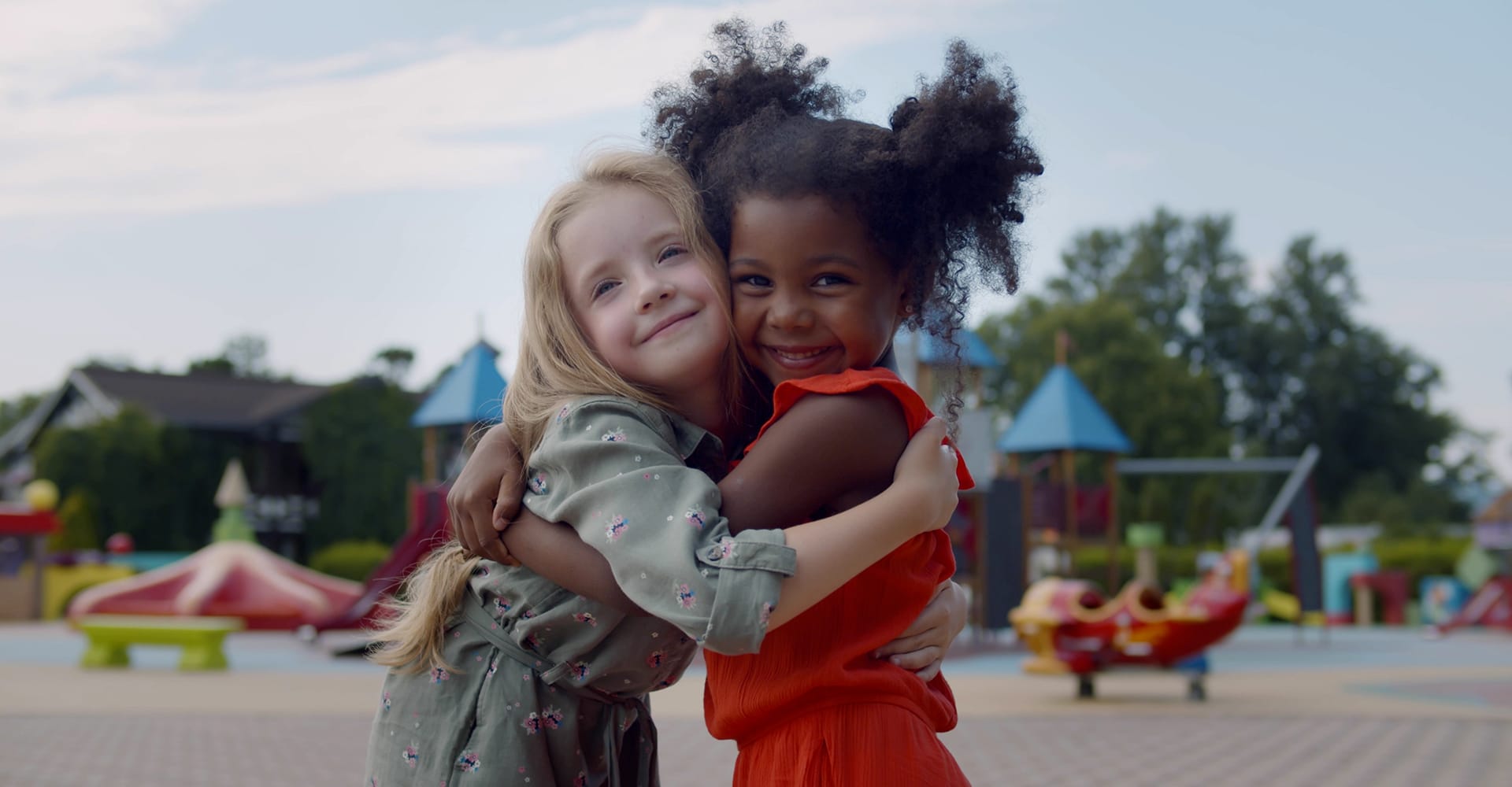 Girls Hugging On Playground